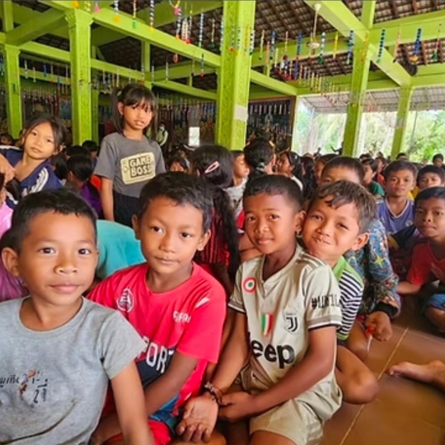 Young ODA students sitting together in an open-air hall