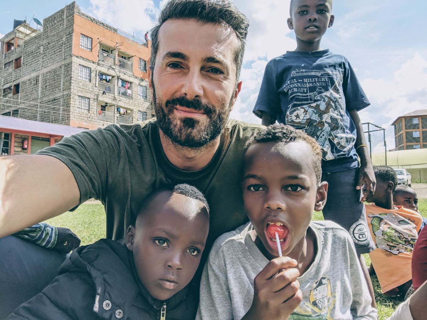 A Friends For Kids volunteer taking a selfie with two young boys in Nairobi